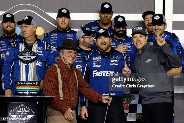 Chris Buescher, driver of the Fastenal Ford, celebrates with team owners Jack Roush and Brad Keselowski, driver of the Kohler Generators Ford, in the...