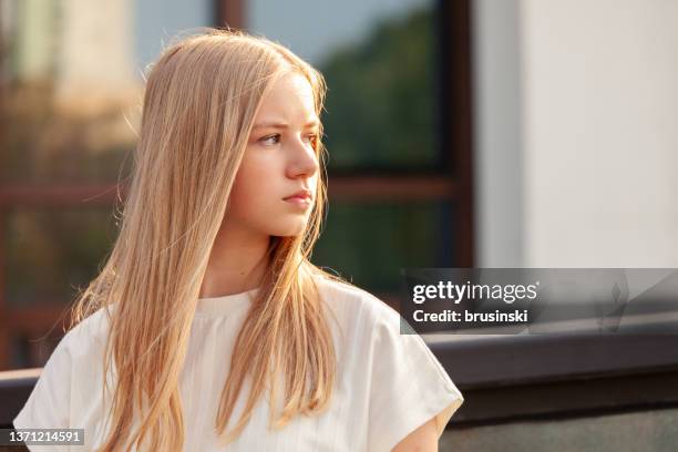 outdoors portrait of 15 year old blonde teen girl with long hair in white t-shirt - 14 year old blonde girl stock pictures, royalty-free photos & images