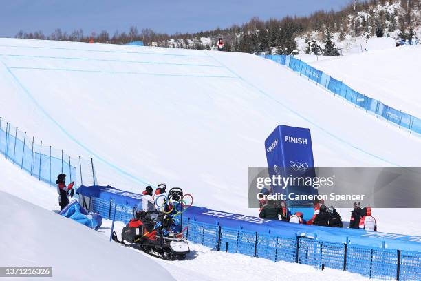 Officials are seen repairing the finish line stand after it collapsed during the Men's Ski Cross Qualification on Day 14 of the Beijing 2022 Winter...