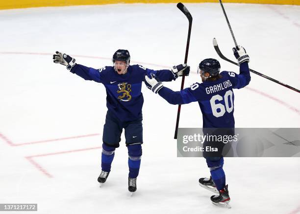 Sakari Manninen of Team Finland celebrates with Markus Granlund after scoring a goal in the first period during the Men's Ice Hockey Playoff...