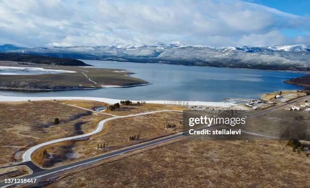 hebgen lake aerial view with mountain view and road. montana, usa - gallatin county montana stockfoto's en -beelden