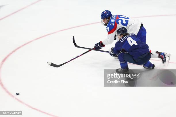 Juraj Slafkovsky of Team Slovakia and Mikko Lehtonen of Team Finland vie for the puck in the third period during the Men's Ice Hockey Playoff...