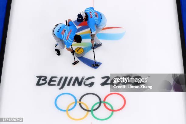 John Landsteiner and Christopher Plys of Team United States compete against Team Canada during the Men's Curling Bronze Medal Game on Day 14 of the...