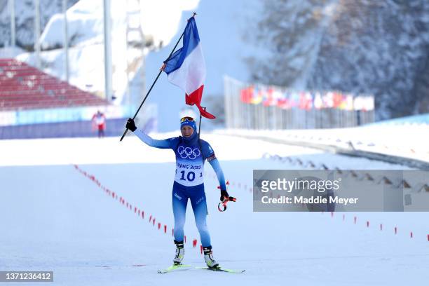 Justine Braisaz-Bouchet of Team France celebrates winning gold during Women's Biathlon 12.5km Mass Start on day 14 of 2022 Beijing Winter Olympics at...