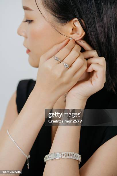 an asian woman portrait is wearing diamond earring - skin diamond stock pictures, royalty-free photos & images