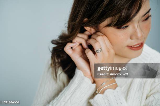 portrait of young beautiful asian woman wearing diamond earring - bracelet stock pictures, royalty-free photos & images