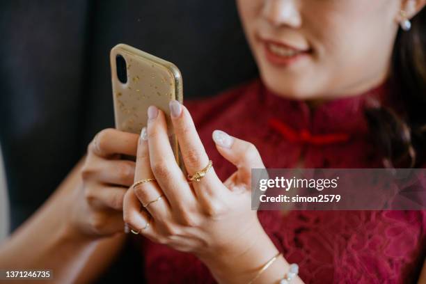 beautiful asian business woman using smartphone while working at office - silver bracelet stock pictures, royalty-free photos & images