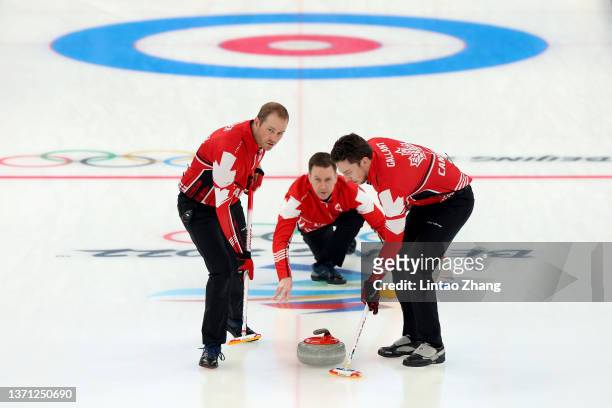 Geoff Walker, Brad Gushue and Brett Gallant of Team Canada compete against Team United States during the Men's Curling Bronze Medal Game on Day 14 of...