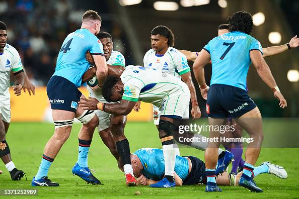 Apisalome Vota of Fijian Drua is tackled during the round one Super