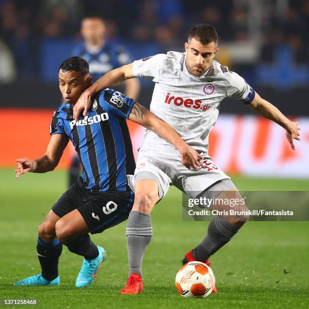 Luis Muriel of Atalanta in action with Sokratis Papastathopoulos of Olympiakos during the UEFA Europa League Knockout Round Play-Offs Leg One match...