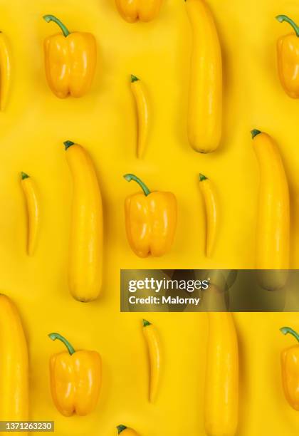 yellow bell peppers, peppers and zucchini on yellow background. - yellow bell pepper stock-fotos und bilder