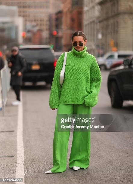 Danielle Bernstein seen wearing green oversized turtleneck, wide leg pants, sunglasses, white heels & bag, outside Prabal Gurung during New Yorker...
