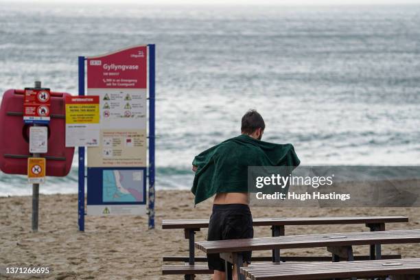 Swimmer dries down after taking a dip in the sea at Gyllyngvase Beach on February 18, 2022 in Falmouth, Cornwall. The Met Office has issued two rare,...