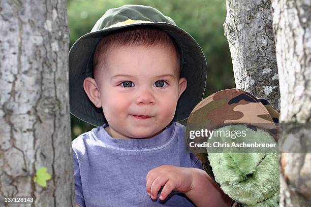 little boy with stuffed animal - real tree camo pattern stock pictures, royalty-free photos & images
