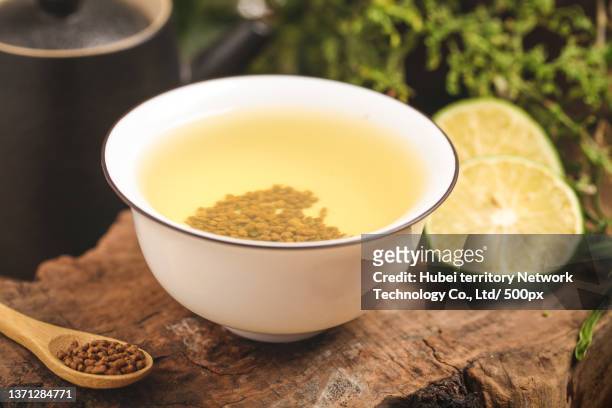 a cup of tartary buckwheat tea on the wooden bottom - tartary buckwheat stock pictures, royalty-free photos & images