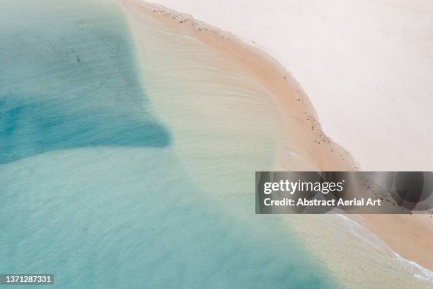 drone shot looking down on an idyllic beach scene, eastern cape, south africa - calm water stock pictures, royalty-free photos & images