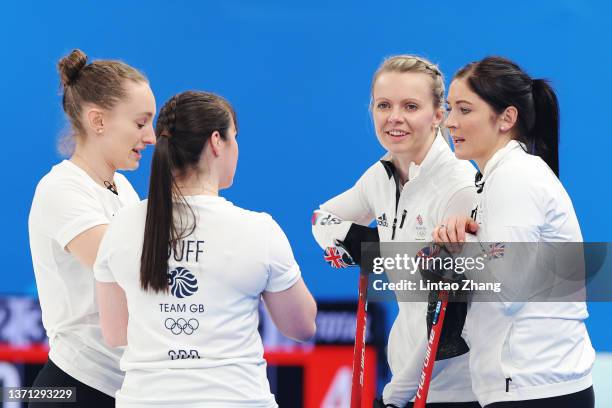 Jennifer Dodds, Hailey Duff, Vicky Wright and Eve Muirhead of Team Great Britain interact while competing against Team Sweden during the Women's...