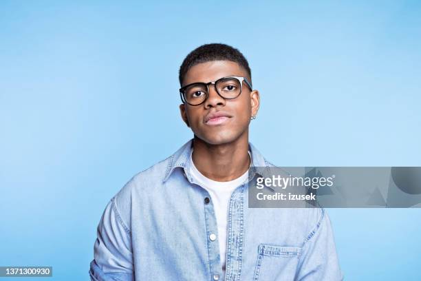 confident young man wearing denim shirt - handsome stock pictures, royalty-free photos & images