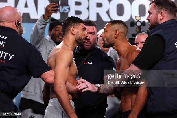 Amir Khan and Kell Brook are held back by security as they go head to head during the official weigh-in at Manchester Central Convention Complex on...