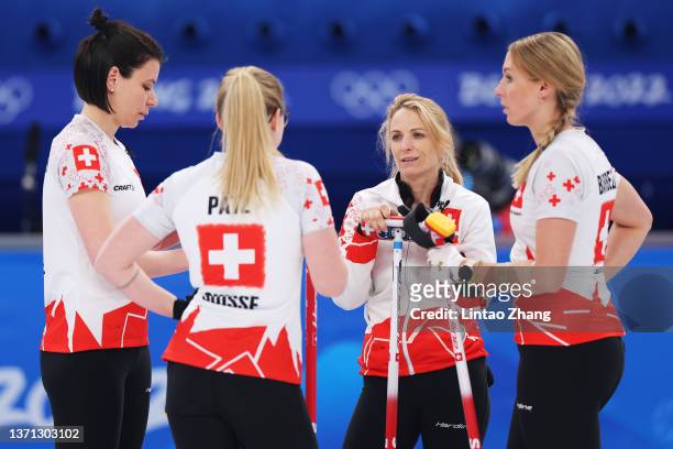 Esther Neuenschwander, Alina Paetz, Silvana Tirinzoni and Melanie Barbezat of Team Switzerland interact while competing against Team Japan during the...