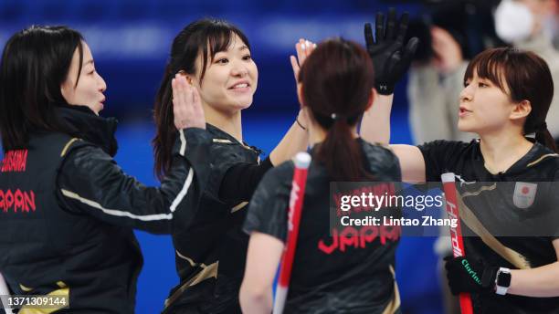 Satsuki Fujisawa, Chinami Yoshida, Yurika Yoshida, and Yumi Suzuki of Team Japan celebrate while competing against Team Switzerland during the...