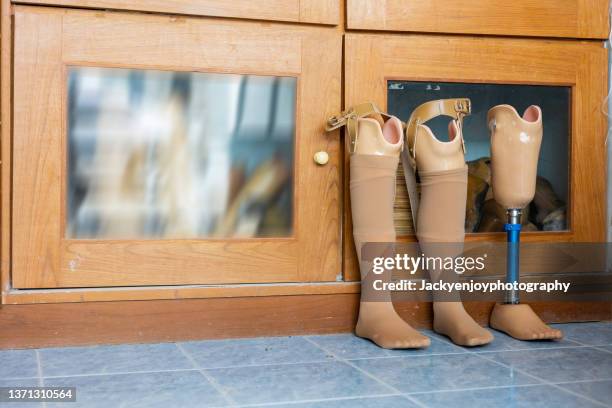 three prosthetic leg isolated on the floor in orthopedic equipment department, disability concept - prosthetic equipment stock pictures, royalty-free photos & images