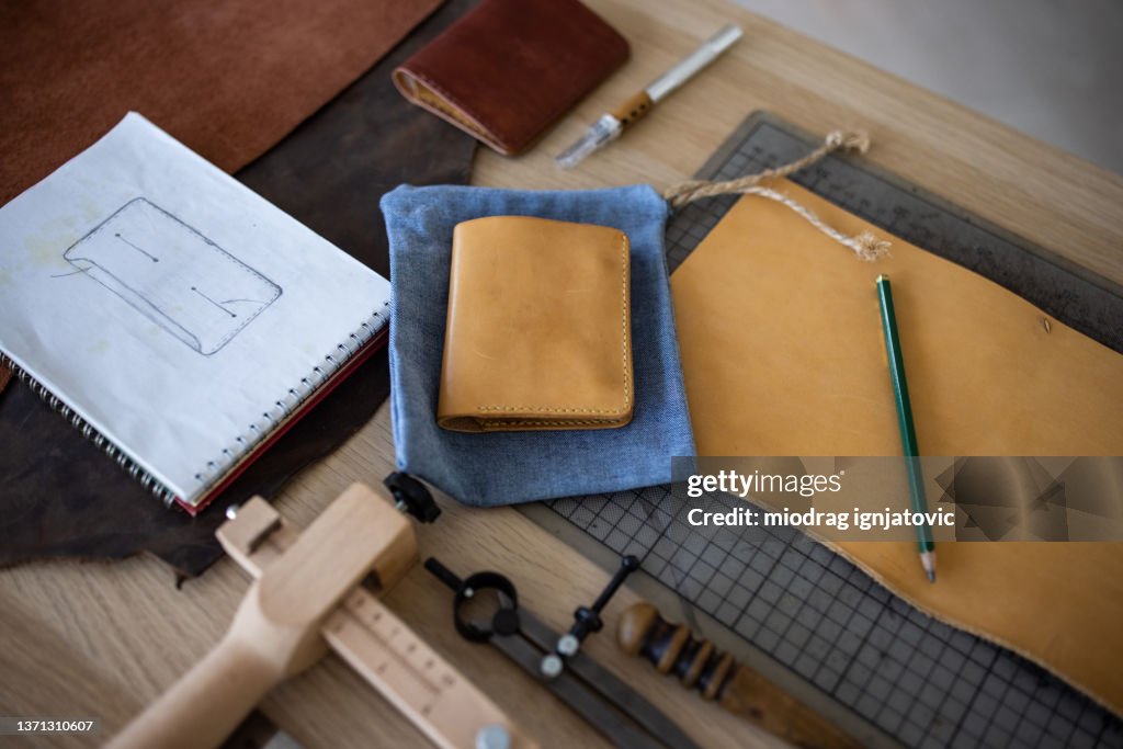 Sketch for new wallet on table in leather crafting workshop