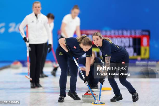 Sara McManus and Sofia Mabergs of Team Sweden compete against Team Great Britain during the Women's Semi-Final on Day 14 of the Beijing 2022 Winter...