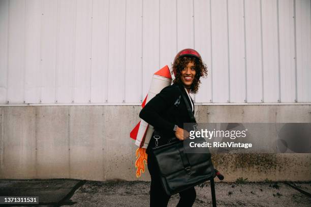 businesswoman with rocket pack - rocket pack stock pictures, royalty-free photos & images