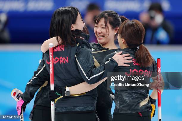 Yurika Yoshida, Satsuki Fujisawa, Chinami Yoshida and Yumi Suzuki of Team Japan celebrate their victory against Team Switzerland during the Women's...