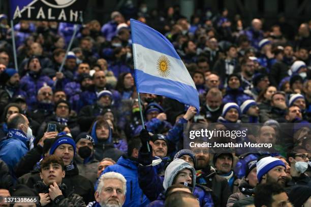 An Argentina flag is waved amongst the Atalanta fans during the UEFA Europa League Knockout Round Play-Offs Leg One match between Atalanta and...