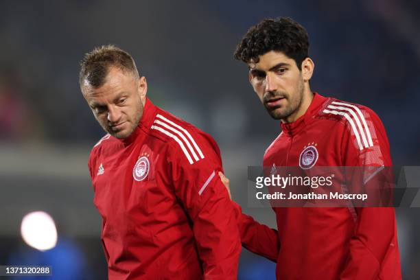 Avraam Papadopoulos and Andreas Bouchalakis of Olympiacos FC during the warm up prior to the UEFA Europa League Knockout Round Play-Offs Leg One...