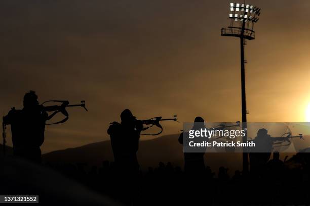 Athletes shoot as they compete in the Men's Biathlon 12.5km Mass Start on Day 14 of the Beijing 2022 Winter Olympics at National Biathlon Centre on...