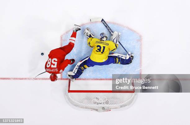 Lars Johansson of Team Sweden makes a save from a shot by Anton Slepyshev of Team ROC during the penalty-shot shootout in the Men's Ice Hockey...