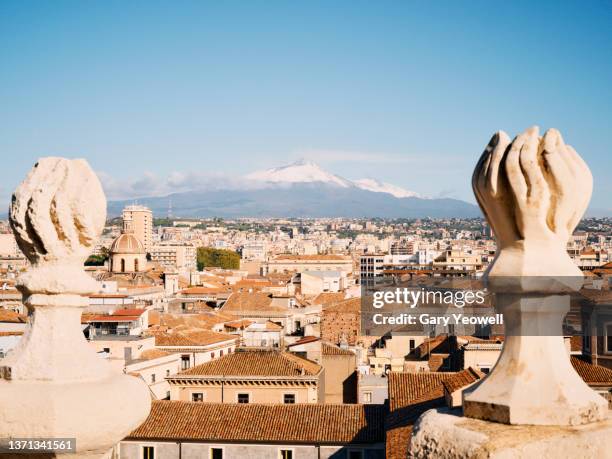 rooftops and mount etna in catania - catania stock pictures, royalty-free photos & images