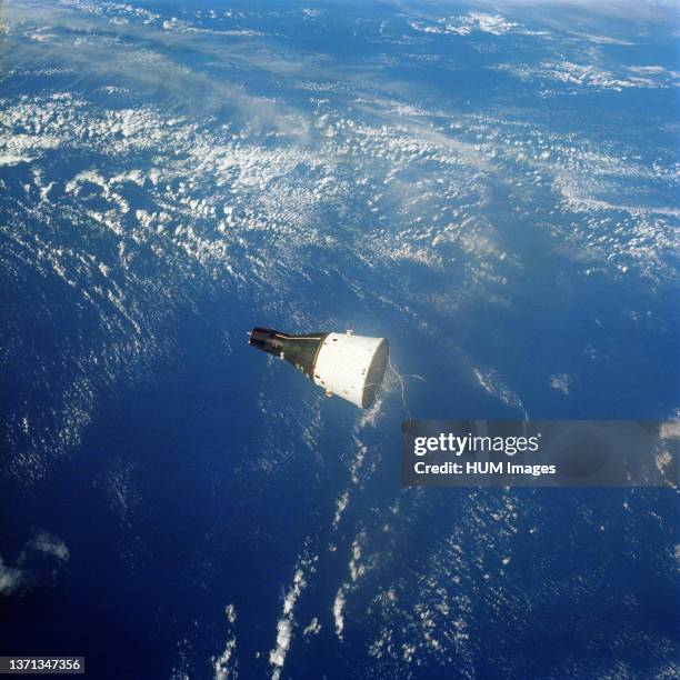 The Gemini-7 spacecraft as seen from the Gemini-6 spacecraft during their rendezvous mission in space. The two spacecrafts are approximately 122 feet...