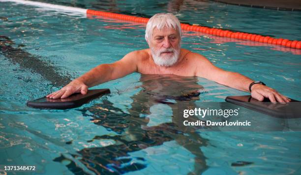 parkinson disease patient in pool exercising - balance - parkinsons disease stock pictures, royalty-free photos & images