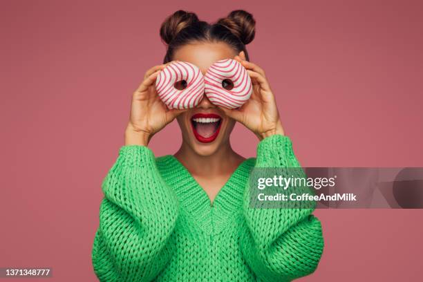 beautiful woman holding donuts - cake isolated stock pictures, royalty-free photos & images