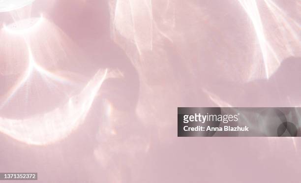 water texture overlay photo effect. rainbow refraction of light over pink background. - com sombra imagens e fotografias de stock