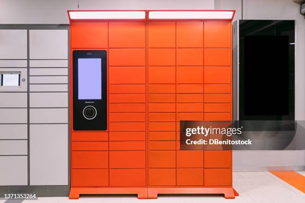 red locker with screen and scanner for storage of packages purchased online. concept of courier, online shopping, e-commerce and packages. - locker foto e immagini stock