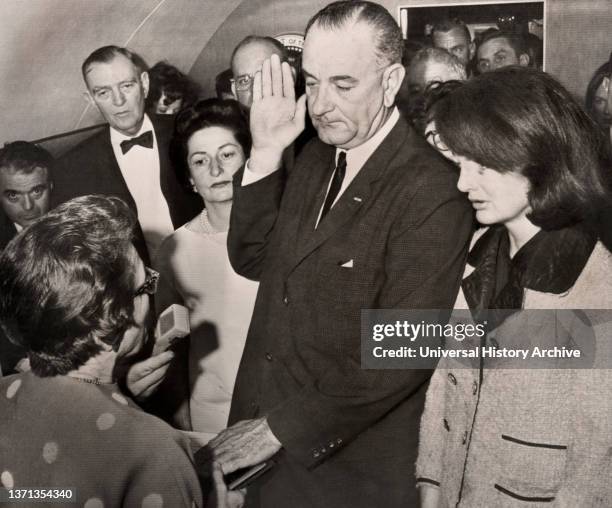 Lyndon Johnson being sworn in as U.S. President by Judge Sarah Hughes aboard Air Force One after assassination of U.S. President John F. Kennedy,...