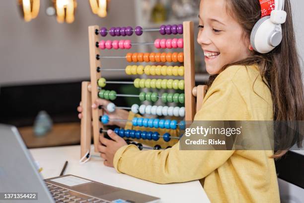 happy girl showing her new abacus to her classmates - abacus computer stock pictures, royalty-free photos & images