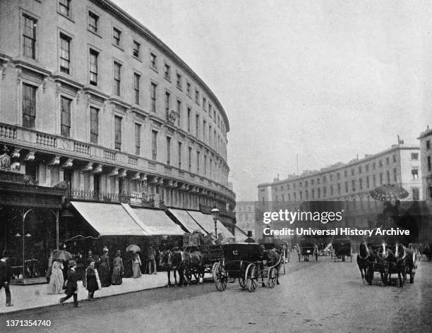 London scene in Regent street with horse drawn buggies and shoppers. 1900.