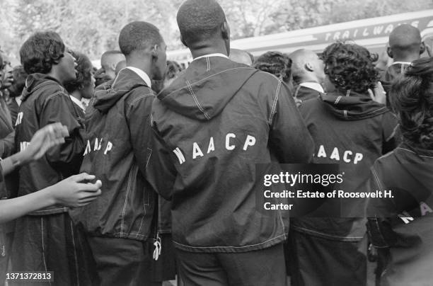 View, from behind, of a group of students, most in NAACP jackets, as they stand outside of a Trailways bus during the March on Washington for Jobs...