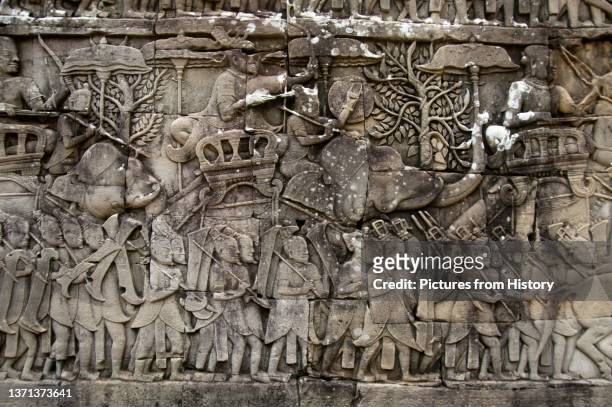 Chinese mercenaries advancing with the Khmer army, bas-relief Eastern Wall, southern section, The Bayon, Angkor Thom. The Bayon was originally the...