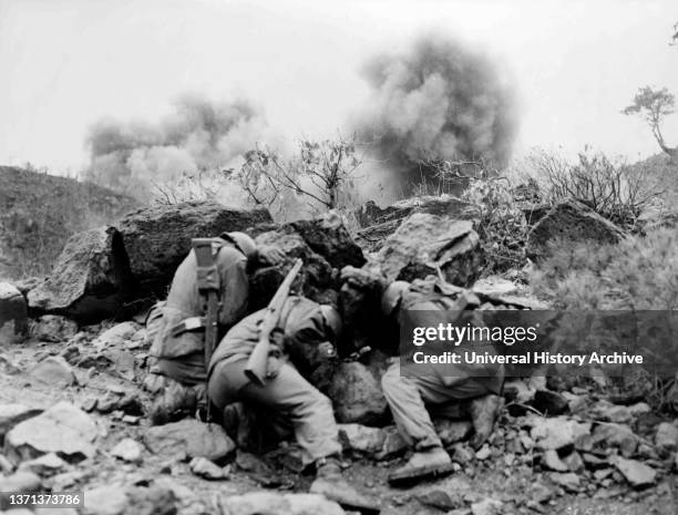 American soldiers shelter under shelling, during a battle in the Korean War. 1951.
