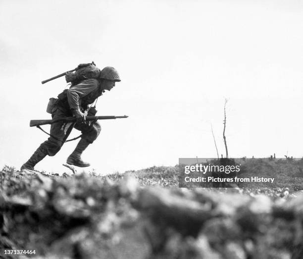 Marine Paul E. Ison charges across 'Death Valley' on April 1, 1945. Battle of Okinawa.