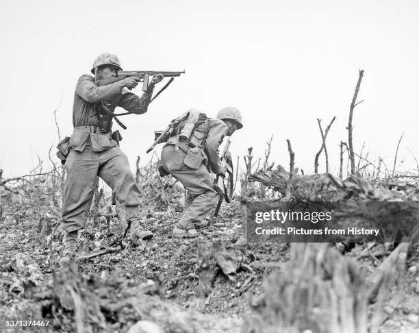 Marine from the 2nd Battalion, 1st Marines on Wana Ridge firing a Thompson submachine gun. Battle of Okinawa, May 1945.