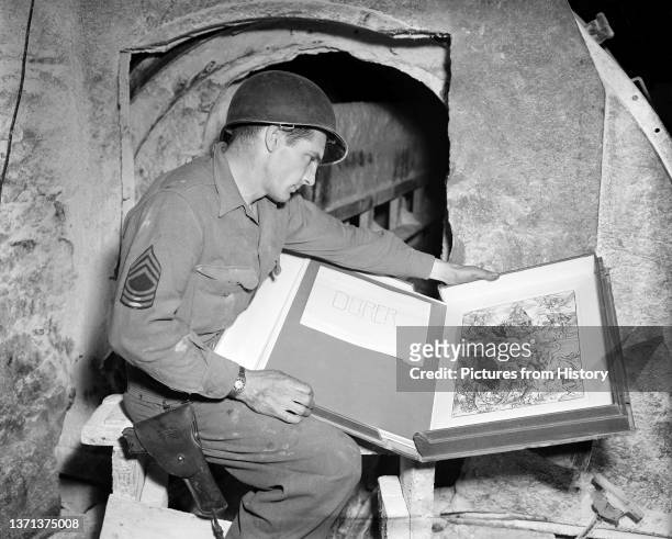 Sgt Harold Maus of Scranton, Pennsylvania, examines an engraving by Albrecht Durer stolen by the Nazis and hidden in Merkers salt mine, Thuringia, 13...