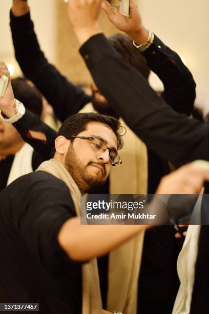 young adult boy dancing and enjoying in traditional (bhangra) style in a party. - folkloric stock-fotos und bilder